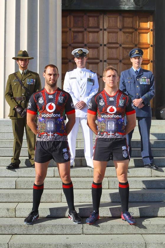 Simon Mannering (L) and Ryan Hoffman with NZ military representatives during the unveiling of the ANZAC playing shirt the Vodafone Warriors will be wearing during their match against the Titans on ANZAC day. Auckland Museum, New Zealand. 25 March 2015. Copyright Photo: William Booth / www.photosport.co.nz