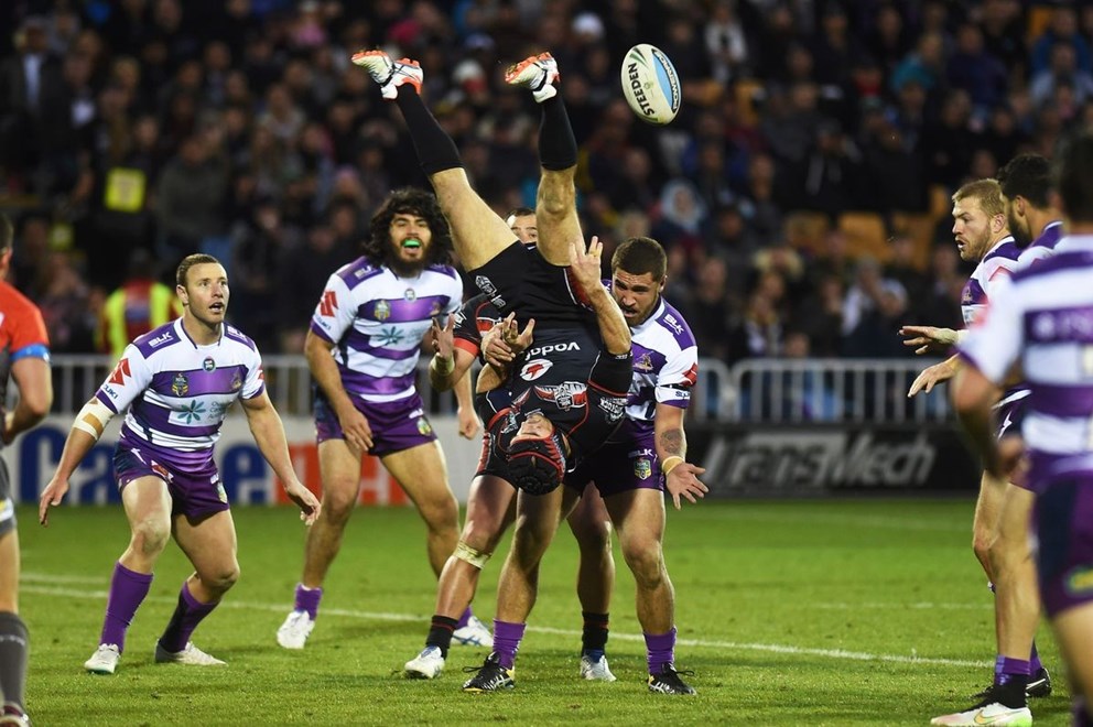 Nathan Friend goes over the top of Kenny Bromwich to pass the ball back during the NRL Rugby League match between the Vodafone Warriors and The Melbourne Storm at Mt Smart Stadium, Auckland, New Zealand. Sunday 12 July 2015. Copyright Photo: Andrew Cornaga / www.Photosport.nz