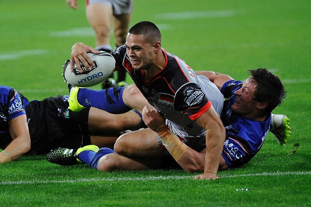 Warriors' Tuimoala Lolohea  scores a try as he is tackled by Bulldogs' Josh Jackson during the NRL Warriors vs Bulldogs Rugby League match at the Westpac Stadium in Wellington on Saturday the 16th of April 2016. Copyright Photo by Marty Melville / www.Photosport.nz