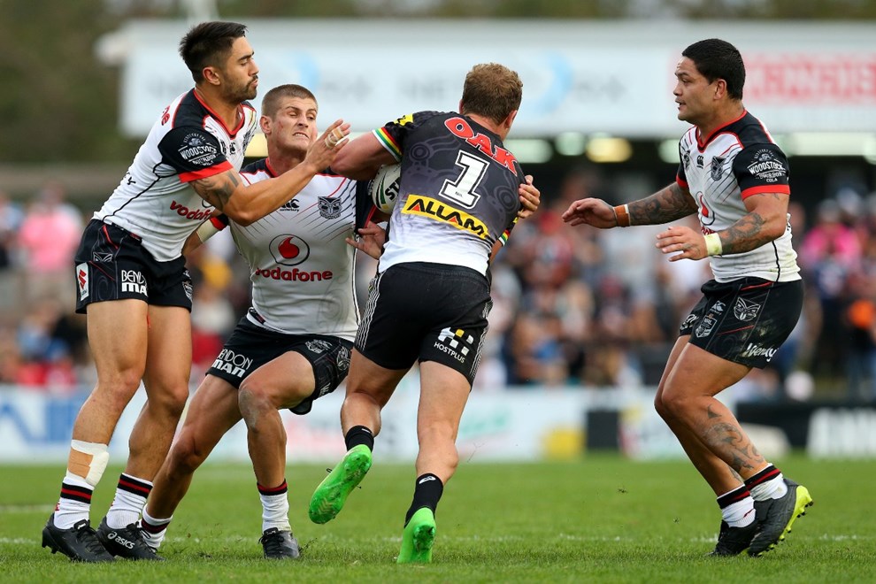 Matt Moylan of the Panthers is tackled by Shaun Johnson